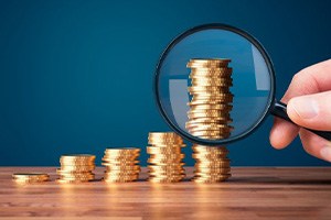Coins examined with magnifying glass