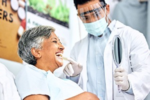 Dentist showing patient smiling in reflection