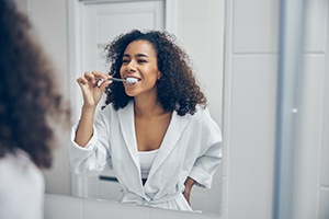 Patient in Toronto brushing their dental implants