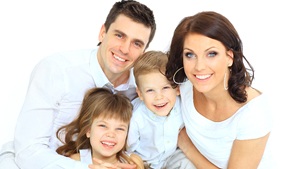 Small family smiling at dentist.