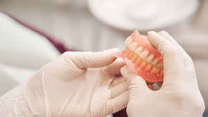 Dentist looking at custom dentures in Toronto