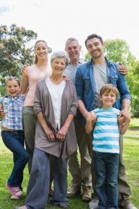 Happy extended family standing at park