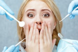 panicked person surrounded by dental tools