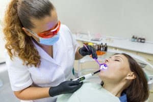 young woman comfortably receiving care with sedation dentistry in M5R