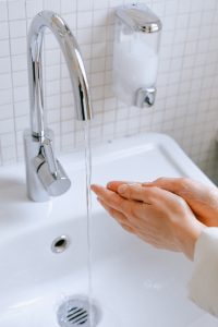 Sleep dentist washing their hands at a sink. 