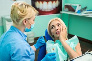 Woman at dentist for a loose dental implant