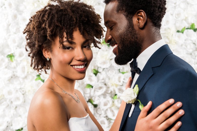 A bride and groom smiling at their wedding after teeth whitening