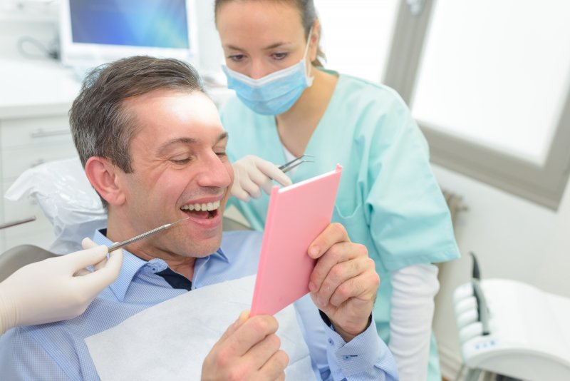 A man smiling with his new dental crowns