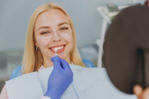 Woman smiling getting veneers at the dentist's office.